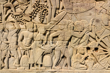 Picturial stories carved into the wall at the Unesco World Heritage site of Ankor Thom, Siem Reap, Cambodia