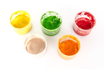 jars with acrylic paint on white background