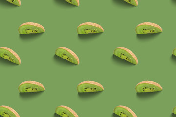 Kiwi slices pattern on a green background. Food texture. Kiwi seamless texture.