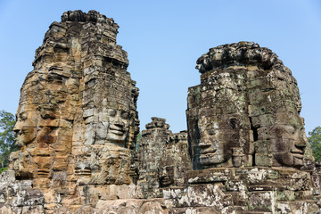 Fototapeta premium Multiple large faces of the Buddha are carved in to the side of the Unesco World Heritage site of Ankor Thom, Siem Reap, Cambodia