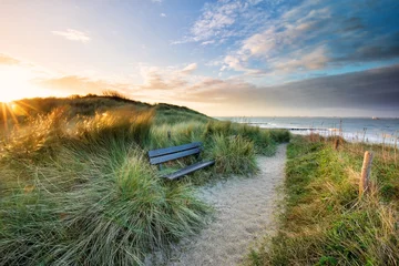 Poster de jardin Mer du Nord, Pays-Bas cozy bench view view on sea beach at sunrise