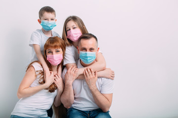 young family in medical masks during home quarantine.