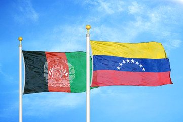 Afghanistan and Venezuela  two flags on flagpoles and blue cloudy sky