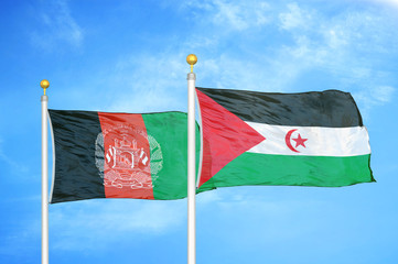 Afghanistan and Western Sahara  two flags on flagpoles and blue cloudy sky