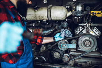 Professional car mechanic working in vehicle repair service.