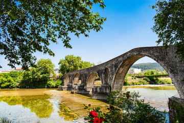 Fototapeta na wymiar The famous stone bridge of Arta, in Epirus region, in Greece. It is the most legendary stone bridge in Greece.