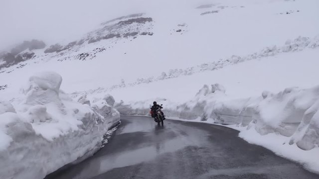 Two bikers on Royal Enfield crossing the famous Baralacha pass in Himachal Pradesh, India.
