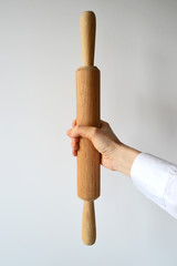 Wooden rolling pin in a human arm