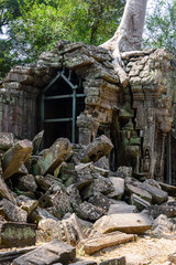 Fototapeta na wymiar Metal scaffolding provide support for walls as the roots of a giant tree threaten to ruin and take over the Unesco World Heritage site of Ankor Thom, Siem Reap, Cambodia