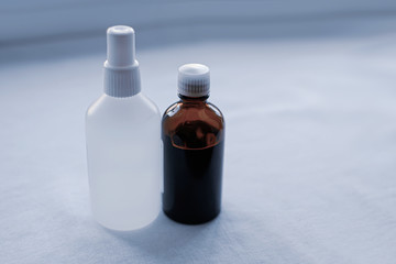 brown and white bottle on a light fabric background. Amber Glass Pharmaceutical Medicine or Chemical Solvent Bottle