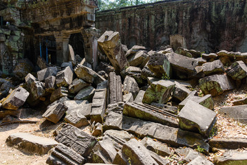 Metal scaffolding provide support for walls as the roots of a giant tree threaten to ruin and take over the Unesco World Heritage site of Ankor Thom, Siem Reap, Cambodia