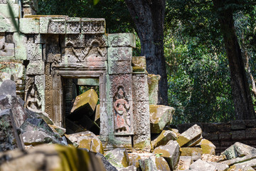 Two Aspara on walls as parts lie in ruins at the Unesco World Heritage site of Ankor Thom, Siem Reap, Cambodia