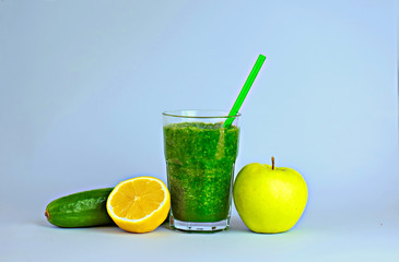 Green detox smoothie with vegetables on blue background