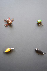 Fishing spinners and wobblers multi-colored on black background.
