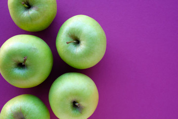 Golden apples with purple background