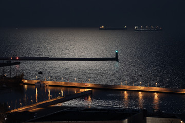 Anchored ships at night waiting to enter port of Gdynia, Poland