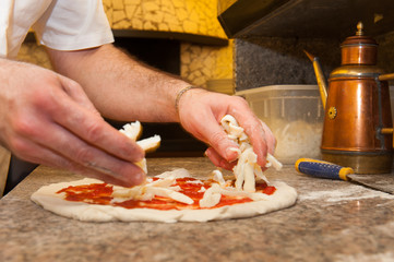 Preparing real italian pizza margherita