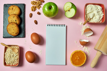 
Cookies on a pink background - ingredients for the dough (eggs, flour, milk, butter, sugar). Background design with free text space.