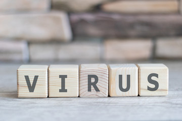 Virus message inscription on a wooden table on cubic blocks. Coronavirus concept.