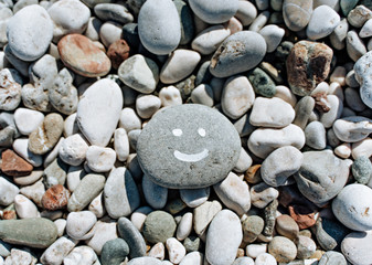 stones on the stone beach with inscription smile
