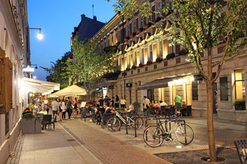 Night city street with bicycles. City bike rental at night