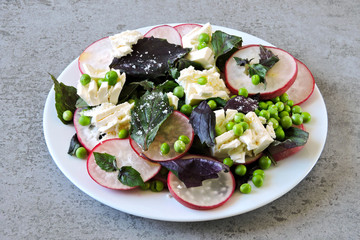 Healthy salad with basil, radish, white cheese and green peas. Cooking at home. Radish Salad. Vegetarian diet. Keto diet. Keto salad.