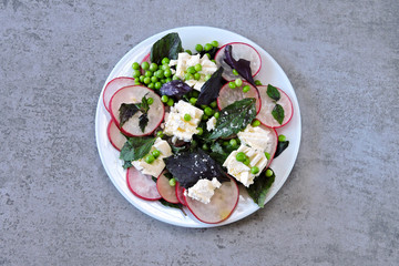 Healthy salad with basil, radish, white cheese and green peas. Cooking at home. Radish Salad. Vegetarian diet. Keto diet. Keto salad.