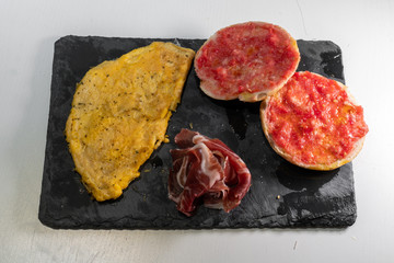 Omelette, bread with tomato and iberic ham