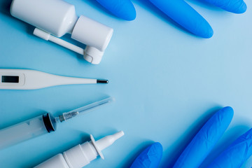 Medical supplies lie on a blue light background.