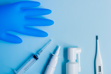 Medical supplies lie on a blue light background.