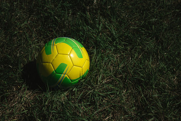 yellow ball lying on the green grass, soccer ball, football