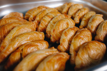 Set of coffee break in the hotel during conference meeting, with tea and coffee catering, decorated catering banquet table with variety of different pastry and bakery, with croissants and cookies