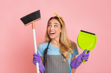 Funny blonde is engaged house cleaning with broom