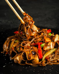 yaki soba. traditional asian buckwheat noodles with teriyaki chicken and fried vegetables. view...