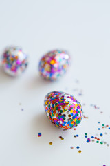 Glitter easter eggs on white background