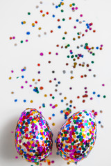 Glitter easter eggs on white background