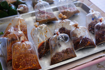 Plastic bags filled with traditional Thai cooking pastes on sale at a market stall, Phuket, Thailand