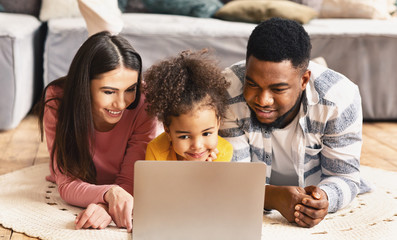 Multiracial family looking at laptop during quarantine