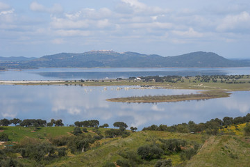 Fototapeta na wymiar Lake reservoir water reflection of Alqueva Dam landscape and Monsaraz on the foreground in Alentejo, Portugal