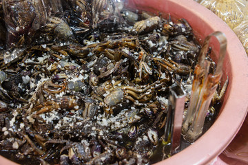 Salted cooked crabs for sale at a Thai street food market stall, Thailand