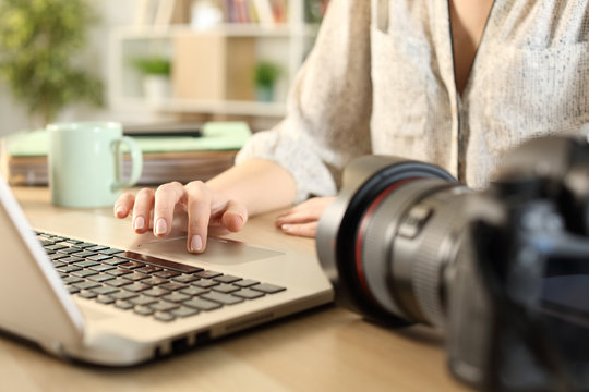 Photographer hands connecting camera and laptop