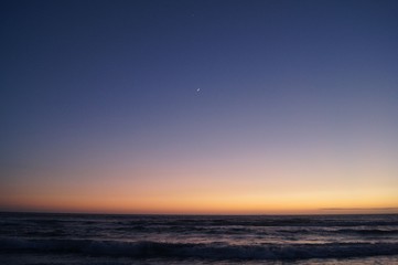 sunset over the sea, Venus and the moon.