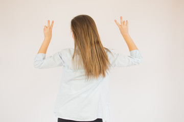 Beautiful young girl making a victory pose