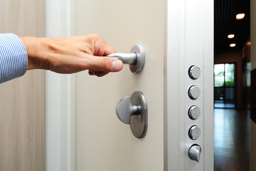 security door - hand close and open the door - security against theft in the apartment - entry and exit - real estate