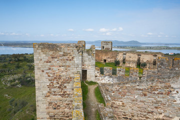 Fototapeta premium Mourao castle towers and wall historic building with alqueva dam reservoir in Alentejo, Portugal
