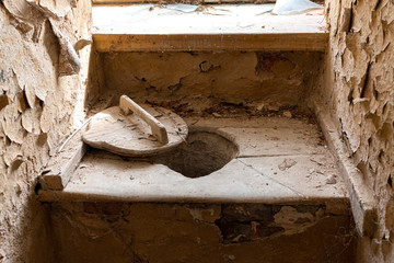 Old style toilet with wooden details in an old abandoned building