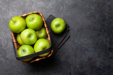 Ripe green apple fruits on dark stone table