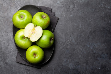 Ripe green apple fruits on dark stone table