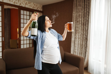 Fototapeta na wymiar Pregnant woman with belly smoking and drinks wine