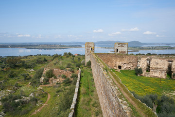 Fototapeta na wymiar Mourao castle towers and wall historic building with alqueva dam reservoir in Alentejo, Portugal